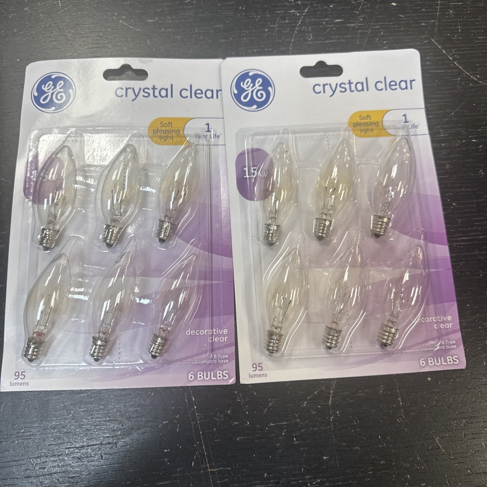 Two packs of GE crystal clear soft white 15 watt decorative light bulbs with six bulbs each in packaging