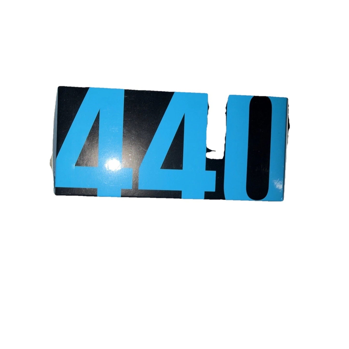 Black and blue rectangular sign with the numbers 440 printed in large bold digits, showing visible damage and missing pieces on the right side.
