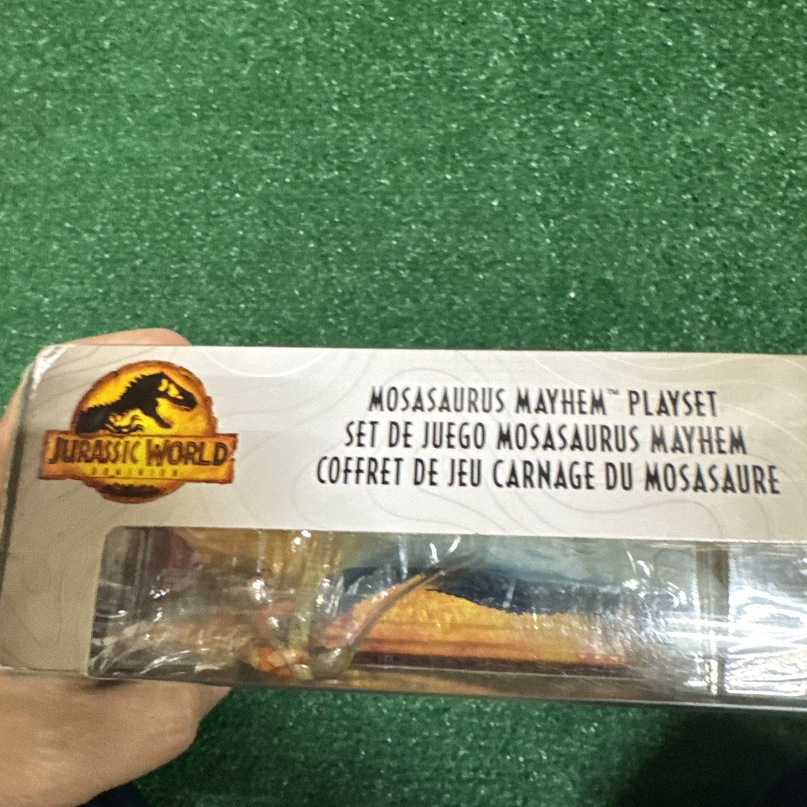 Jurassic World Mosasaurus Mayhem Playset packaging showing toy dinosaur figure partially visible with logo and text on box edge