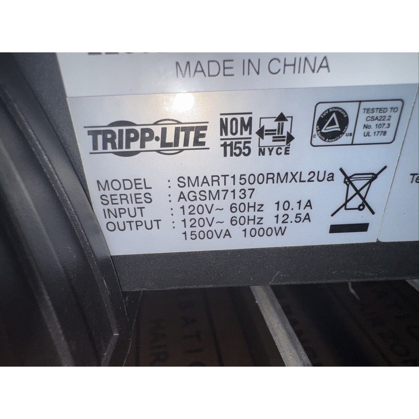 Close-up label of Tripp Lite SMART1500RMXL2Ua UPS with model, input, output, and certification details visible