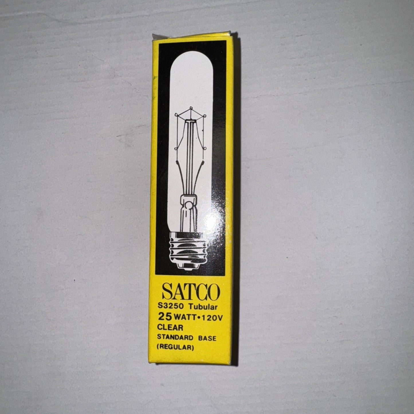 Vintage Satco S3250 tubular light bulb 25W 120V clear glass with standard base in yellow and black box packaging