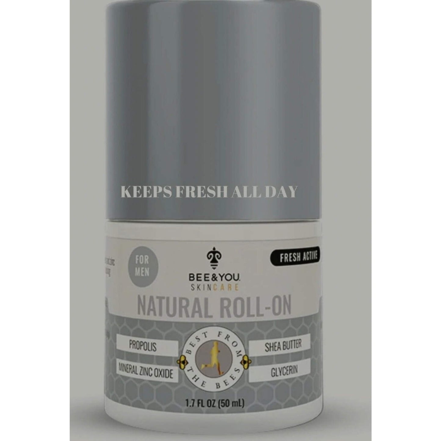 Cylindrical gray and white roll-on deodorant bottle labeled for men, featuring natural ingredients like propolis, shea butter, mineral zinc oxide, and glycerin, with text stating "Keeps fresh all day.