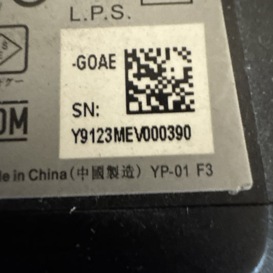 Close-up of power supply label for ADT camera model RC8025 showing serial number and QR code on beige sticker
