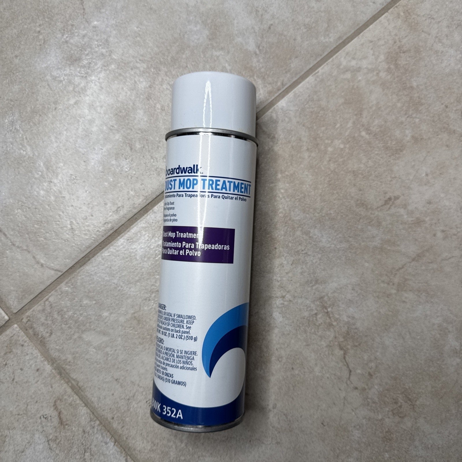 Boardwalk 352ACT 18 oz. spray dust mop treatment can with blue and white label on tiled floor