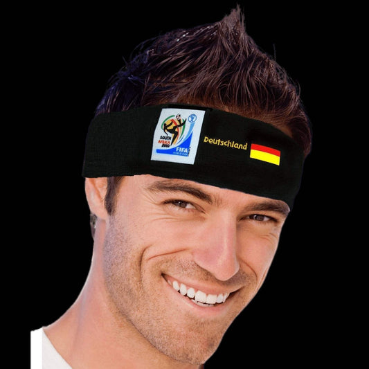 Man smiling wearing a black headband featuring the 2010 FIFA World Cup South Africa logo, the German flag, and "Deutschland" text on a black background.