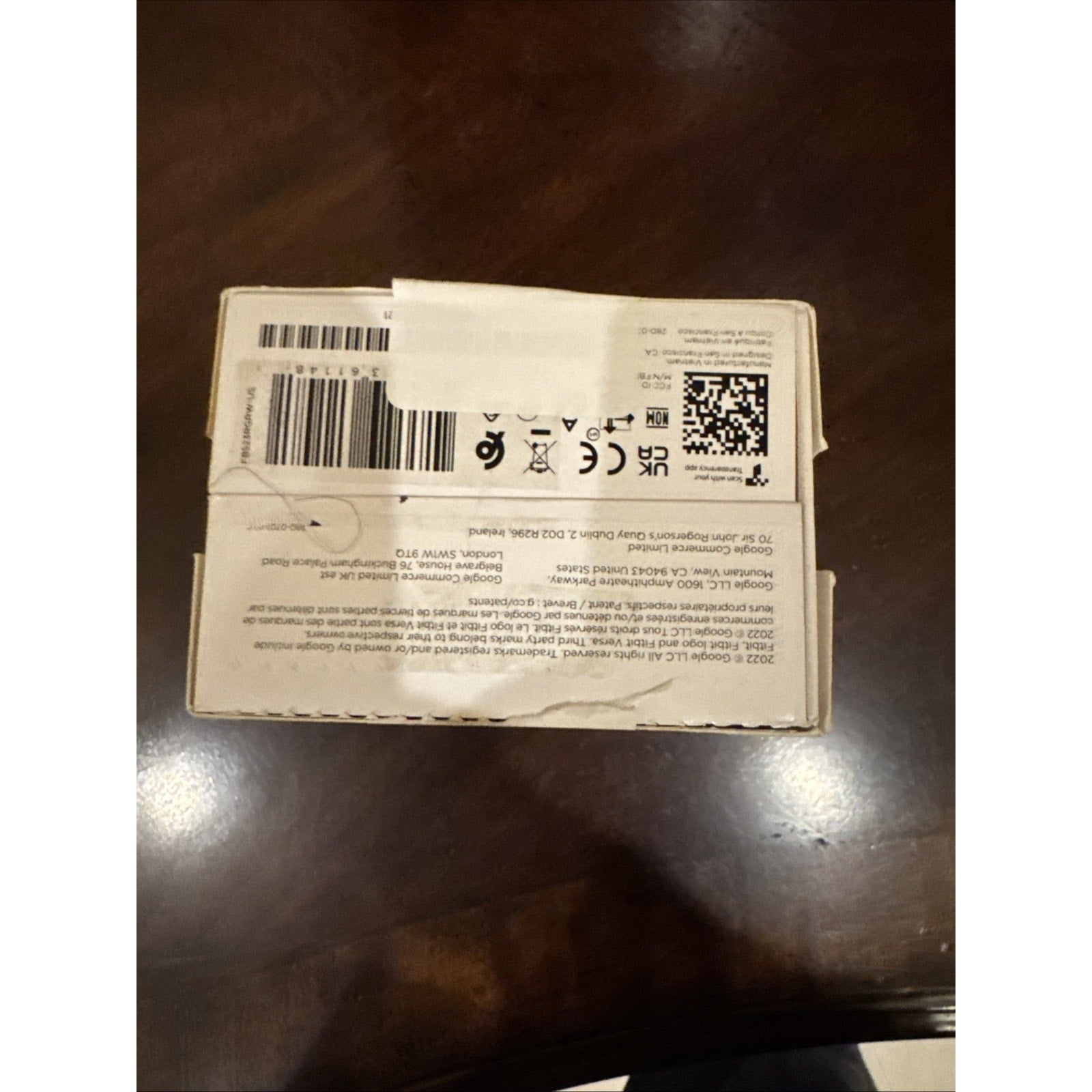 Close-up of Fitbit Versa 4 Smart Watch Pink Sand Copper Rose box bottom showing regulatory and barcode labels