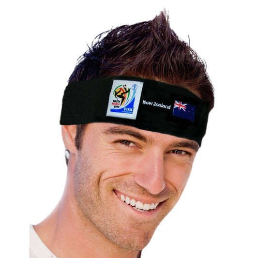 Man smiling and wearing a black headband featuring the 2010 FIFA World Cup South Africa logo, the New Zealand flag, and "New Zealand" text on a white background.
