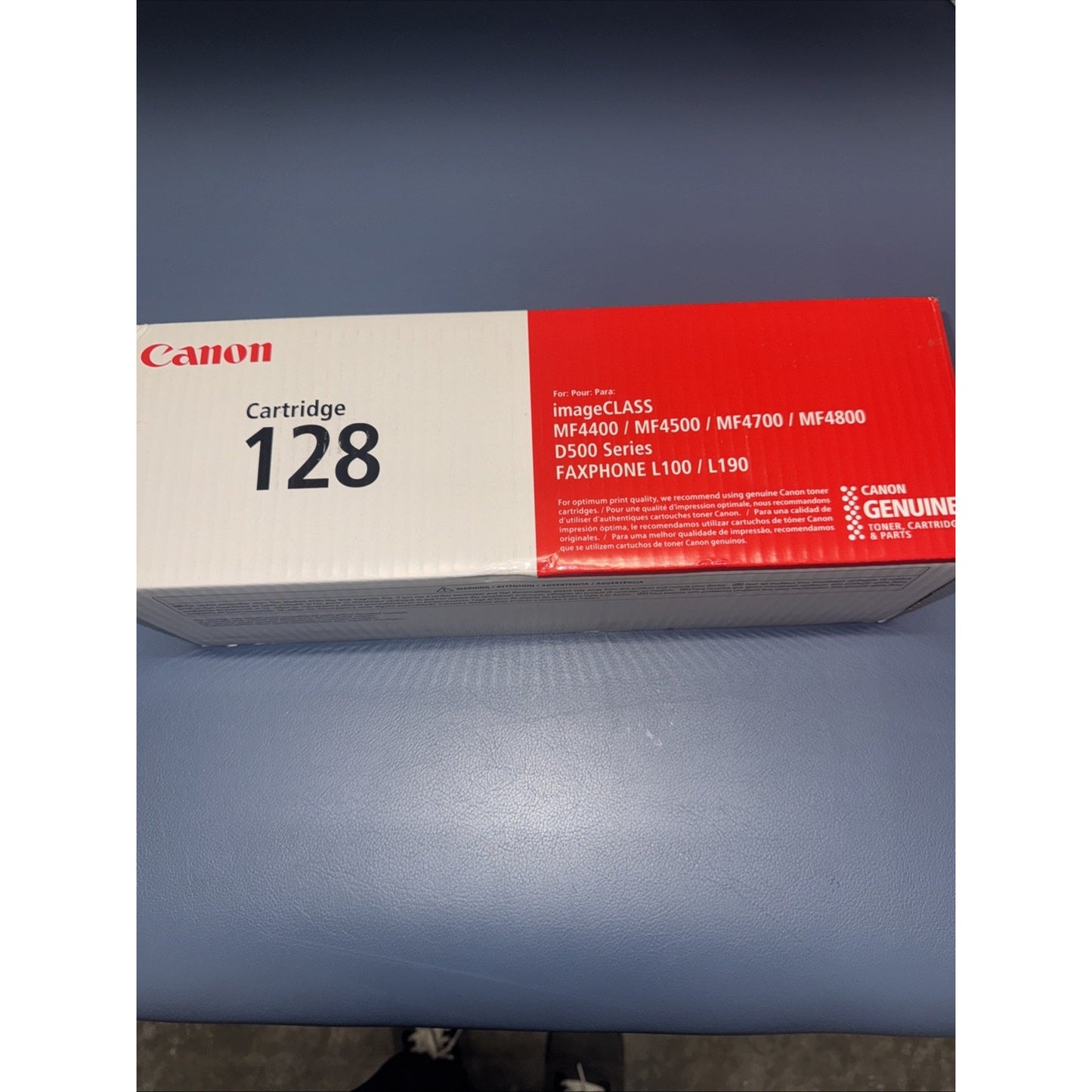 Rectangular Canon toner cartridge box labeled "Cartridge 128" with compatibility for imageCLASS MF4400, MF4500, MF4700, MF4800, D500 series, and FAXPHONE L100/L190 models, featuring red and white packaging.
