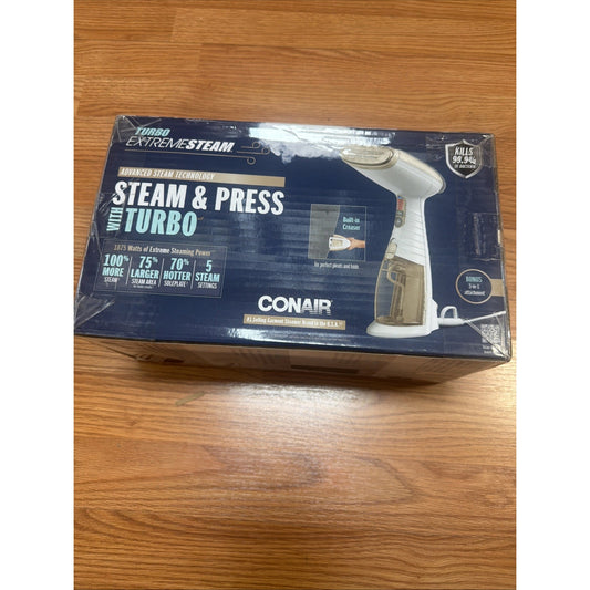 Rectangular retail box for a Conair Turbo Extreme Steam handheld fabric steamer in navy blue and white packaging showing product image, key features, and branding on a wooden surface.