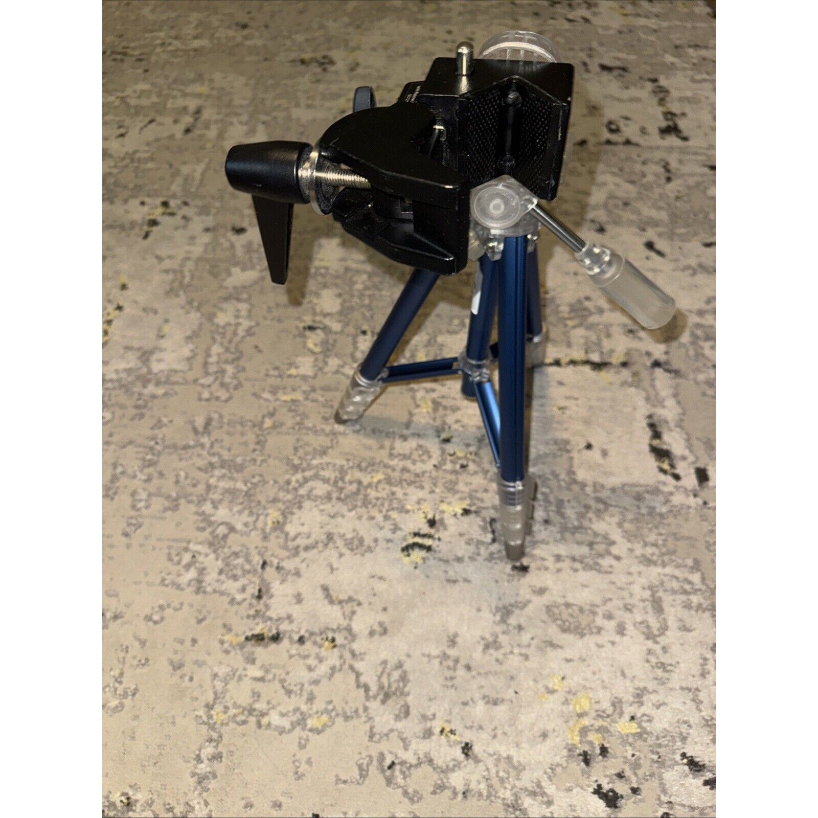 Digipower compact photo and video tripod with adjustable legs and mount for GoPro and cameras on textured floor
