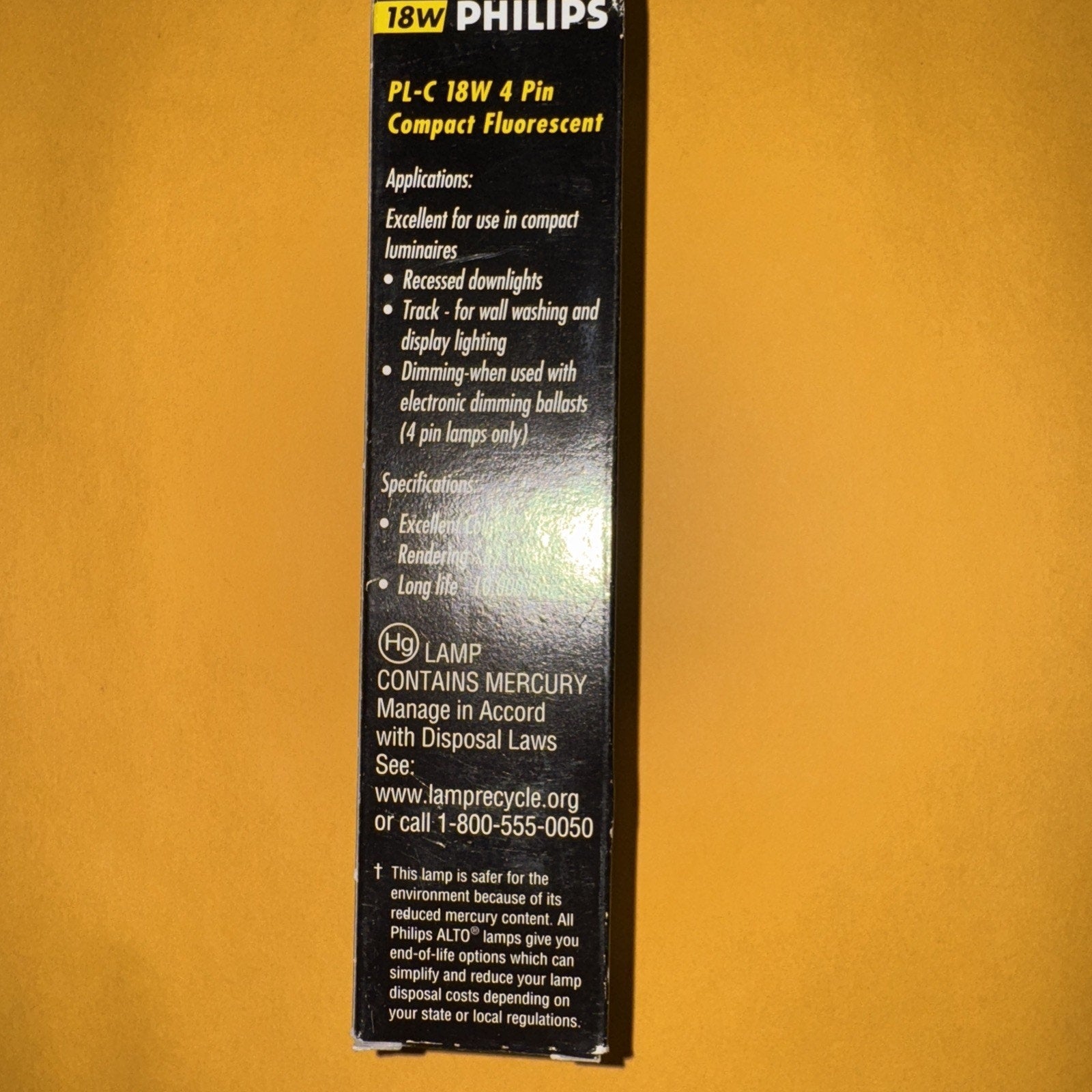 Philips PL-C 18W 4-pin compact fluorescent light bulb packaging with product details and applications text