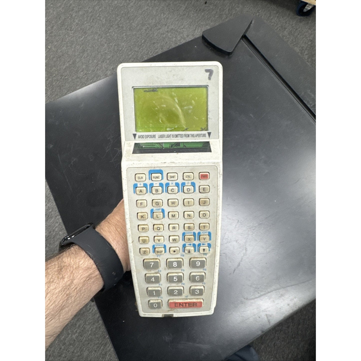 Handheld Symbol barcode scanner with integrated keyboard and small screen for inventory management tasks