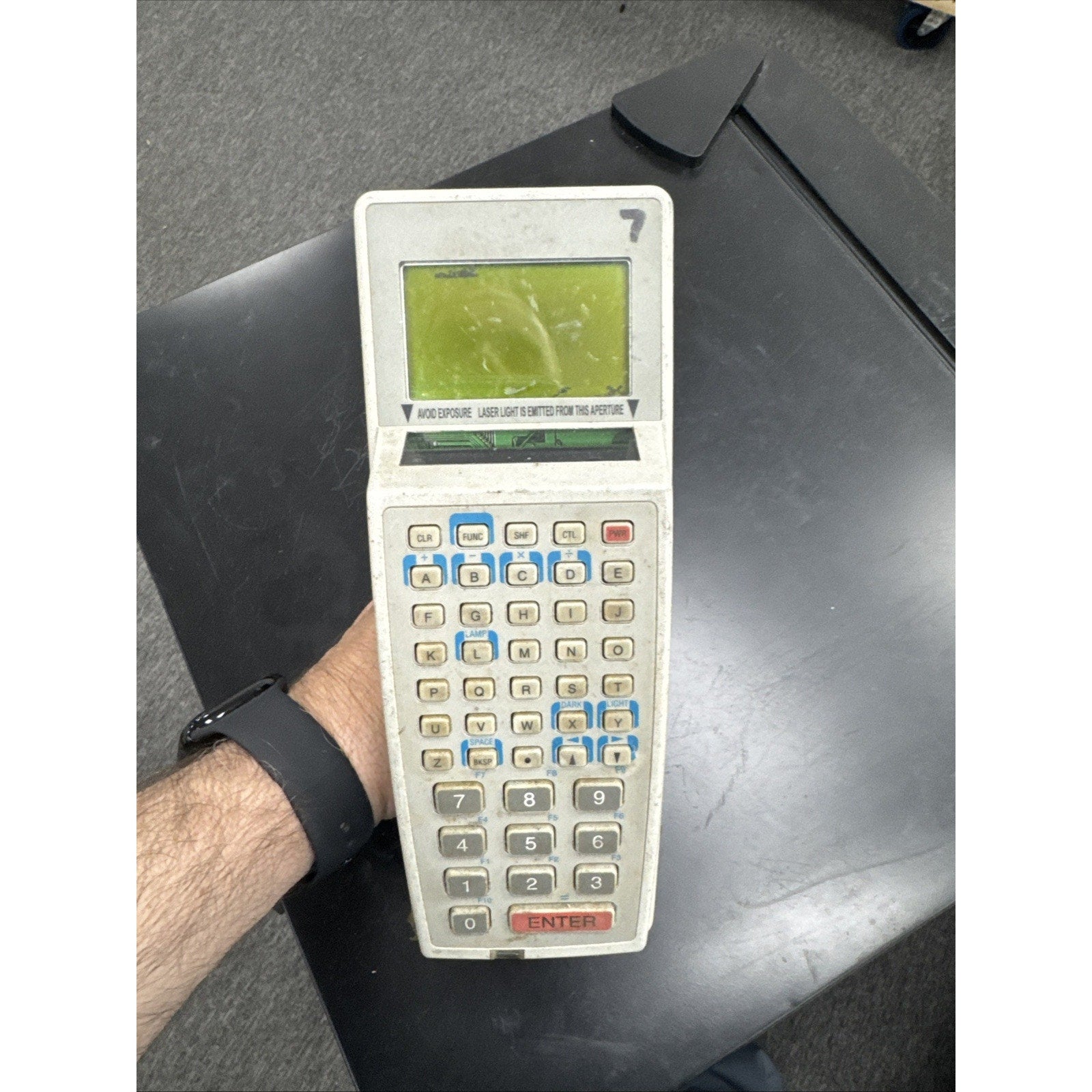 Handheld Symbol barcode scanner with integrated keyboard and small screen for inventory management tasks
