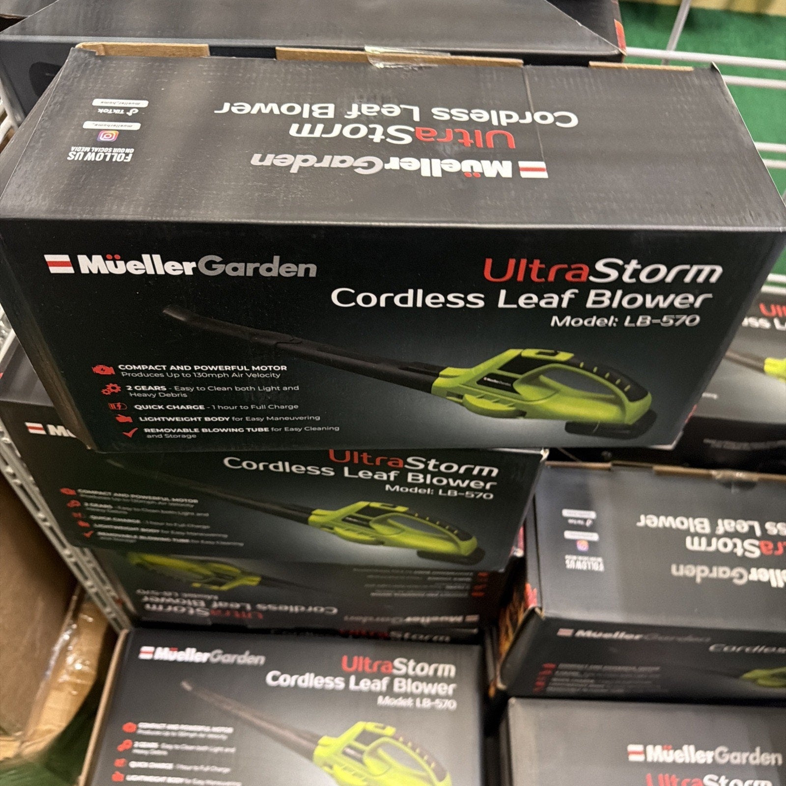 Box packaging for a cordless leaf blower highlighting a compact powerful motor, lightweight design, quick charge feature, and ergonomic blower tube on a black background.