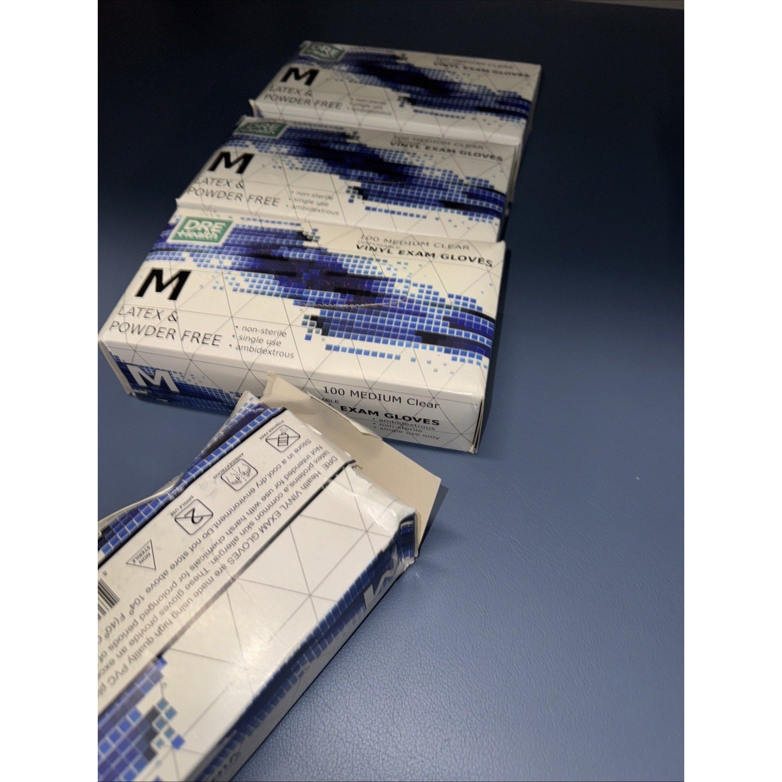 Lot of 4 boxes of DRE HEALTH 100 Medium powder-free vinyl disposable exam gloves in white and blue packaging