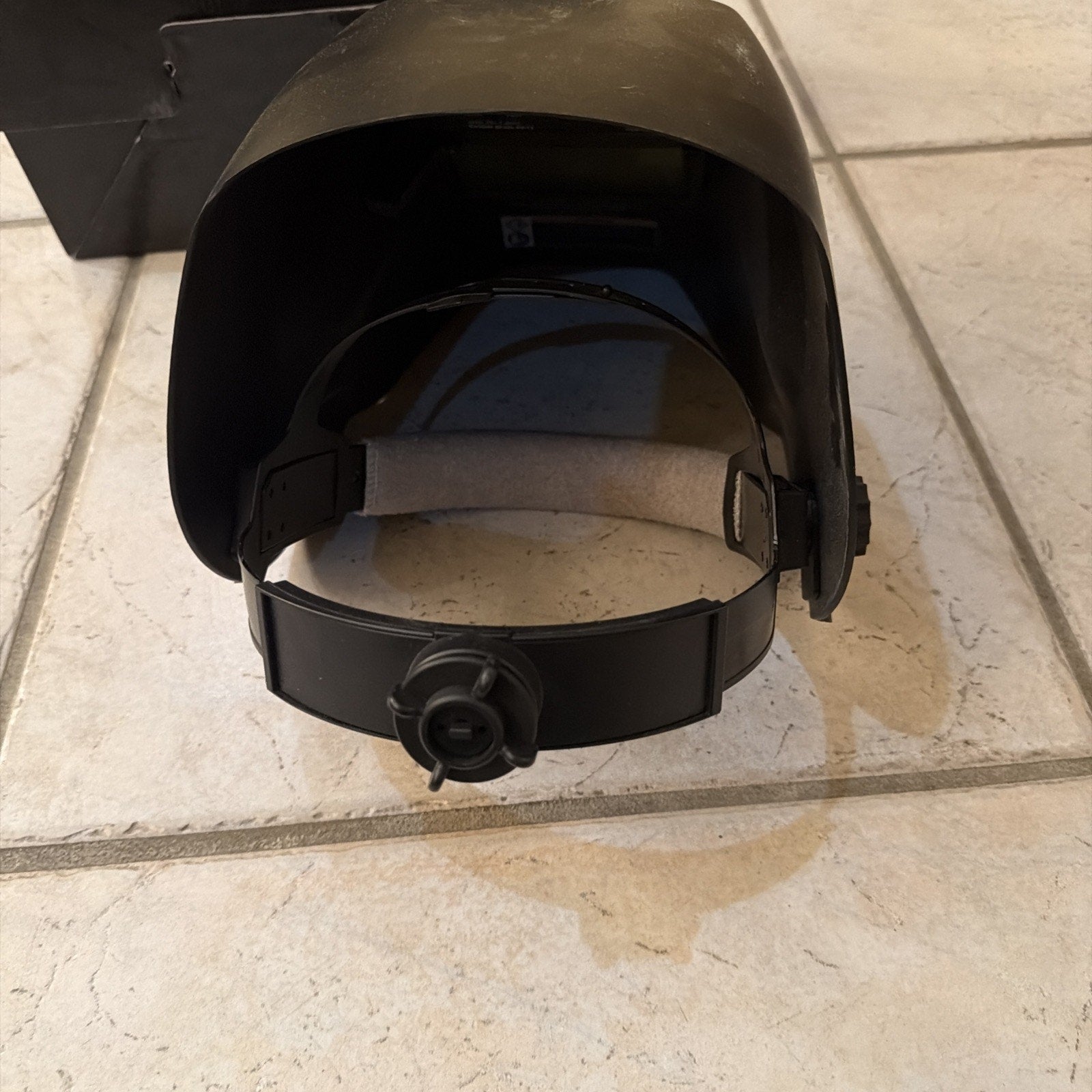 Chicago Electric auto-darkening welding helmet showing adjustable headgear and protective dark lens in black design