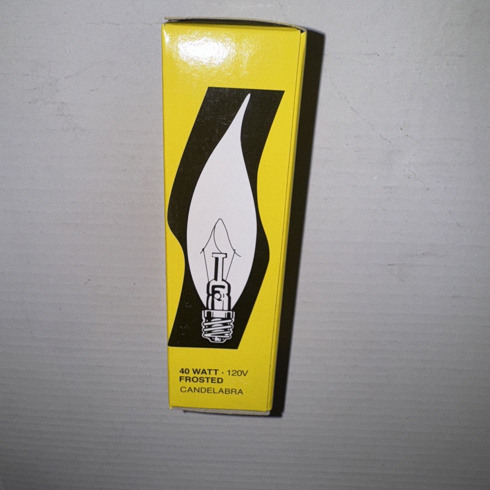 Satco S3279 frosted 40W 120V candelabra base bulb packaging with flame tip graphic on yellow box front