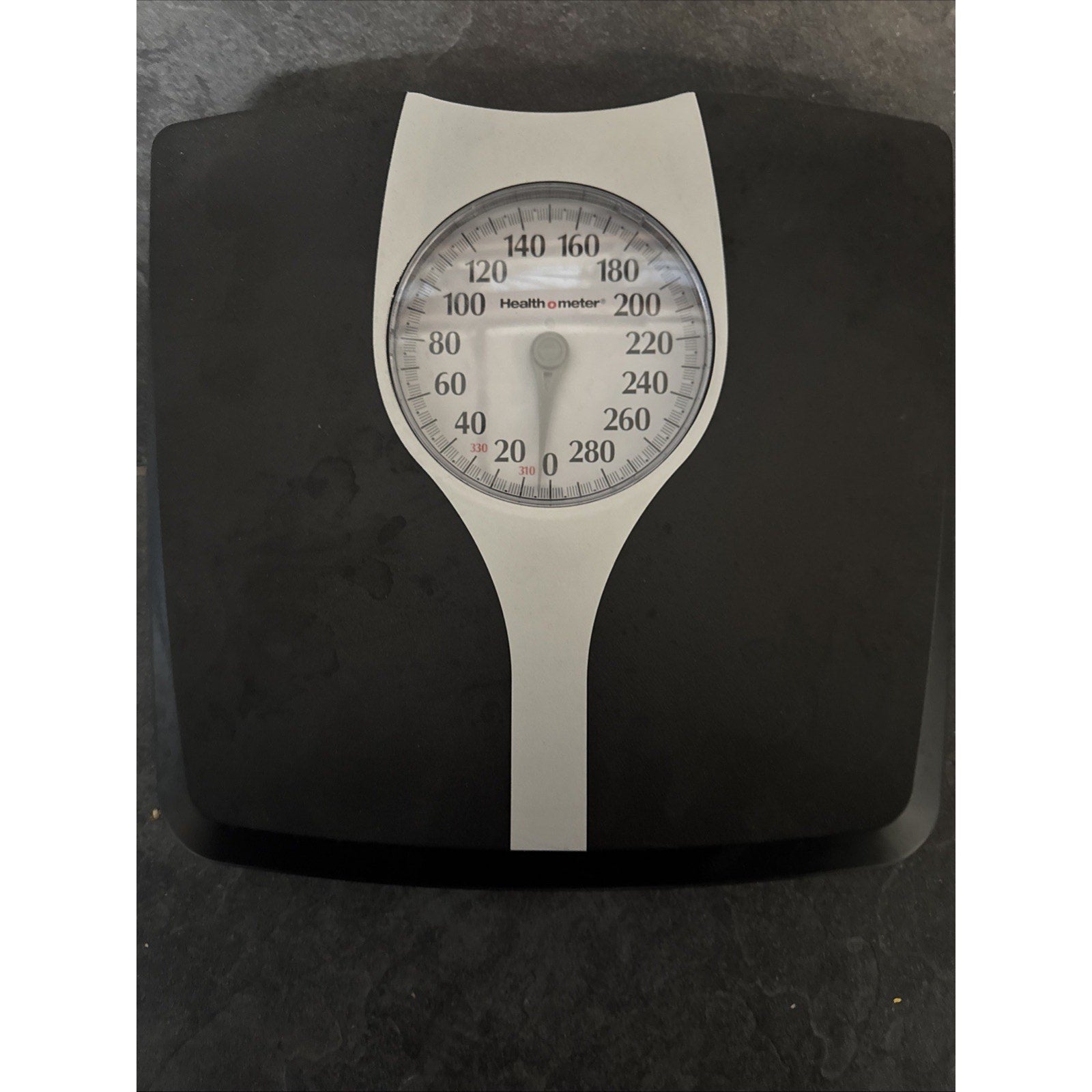 Health O Meter bathroom scale with large oversize dial and black platform showing weight measurements up to 330 pounds