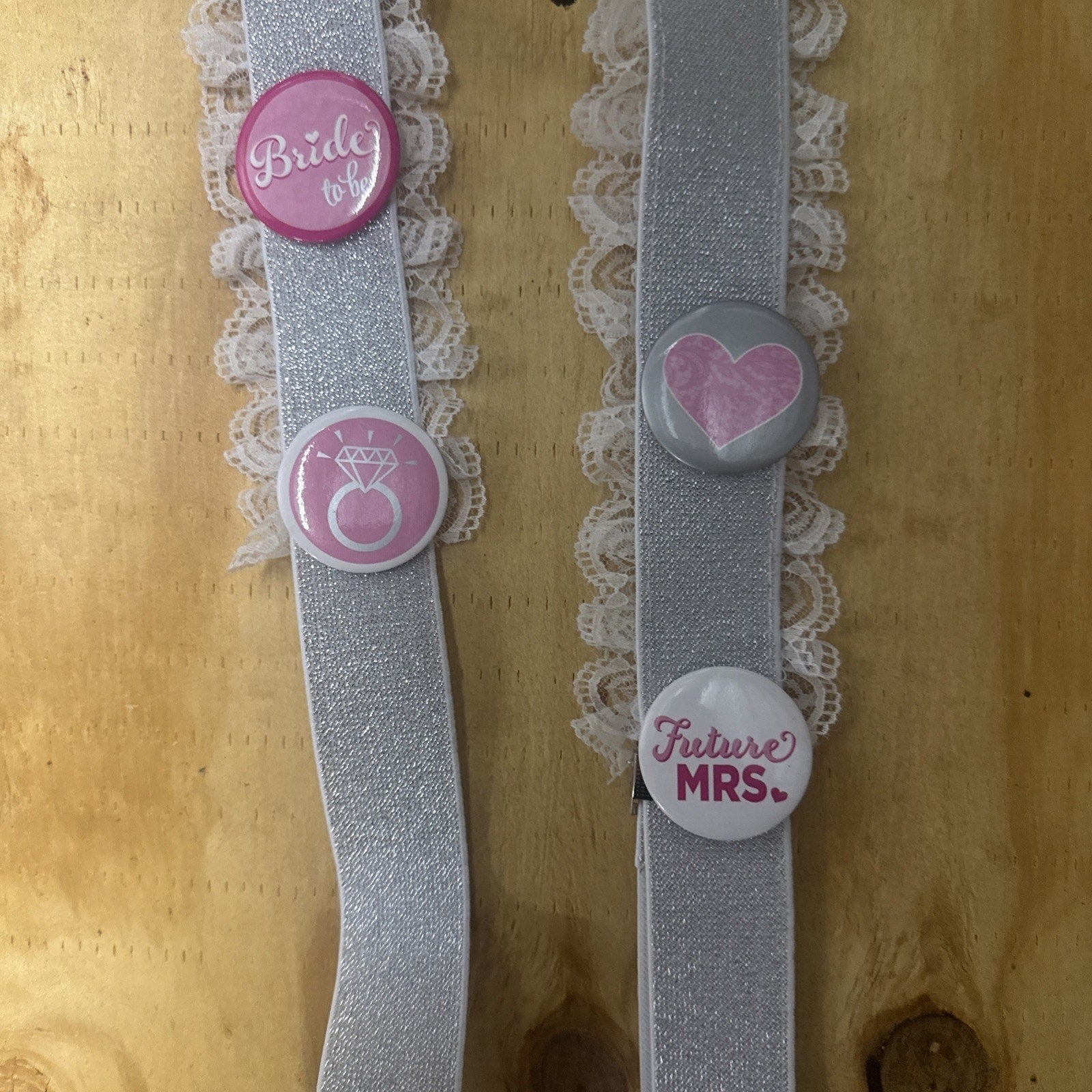 Bridal shower garter suspenders with lace trim and buttons reading Bride to Be, diamond ring, heart, and Future Mrs.