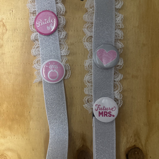 Bridal shower garter suspenders with lace trim and buttons reading Bride to Be, diamond ring, heart, and Future Mrs.