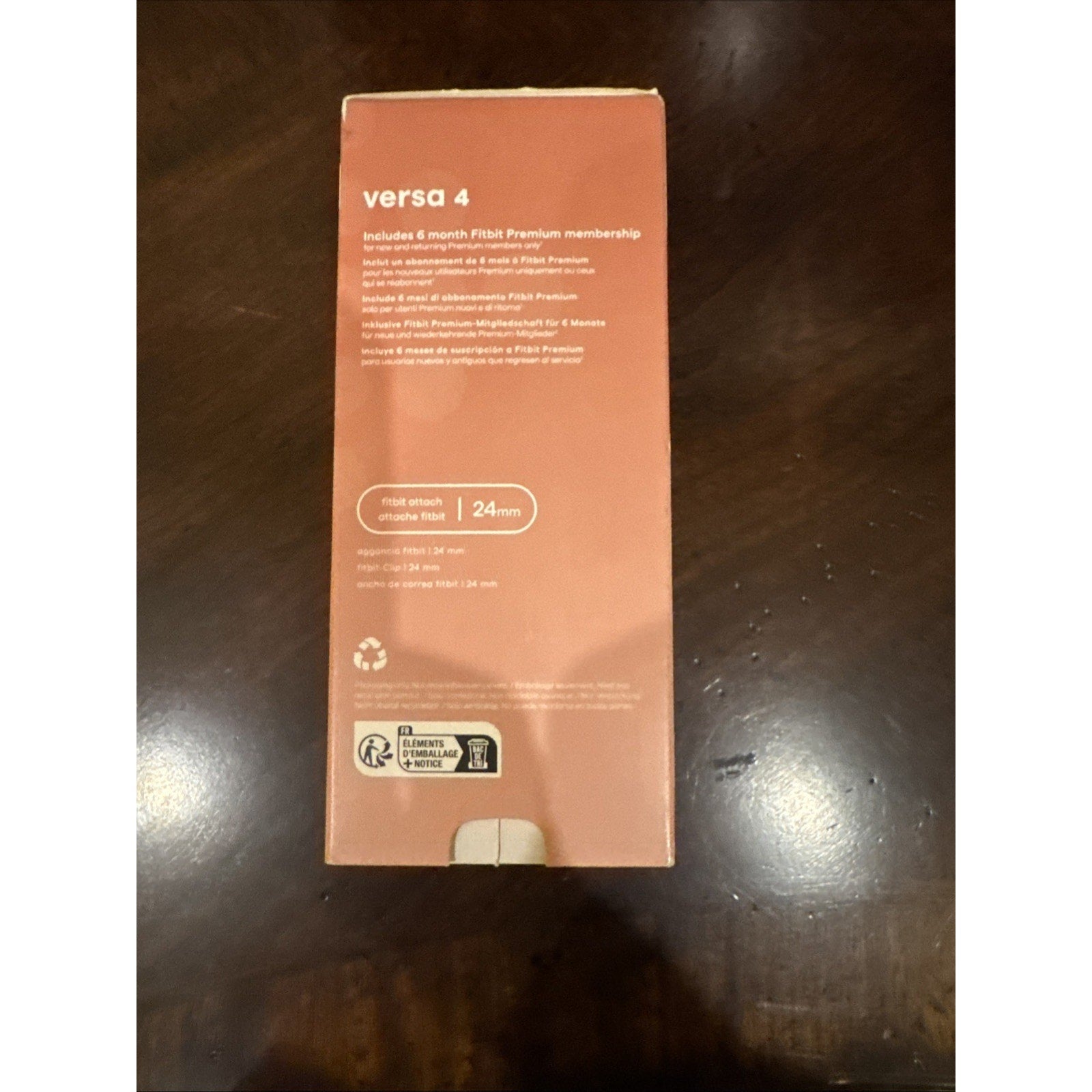 Fitbit Versa 4 smart watch packaging in Pink Sand and Copper Rose showing membership and product details on box back