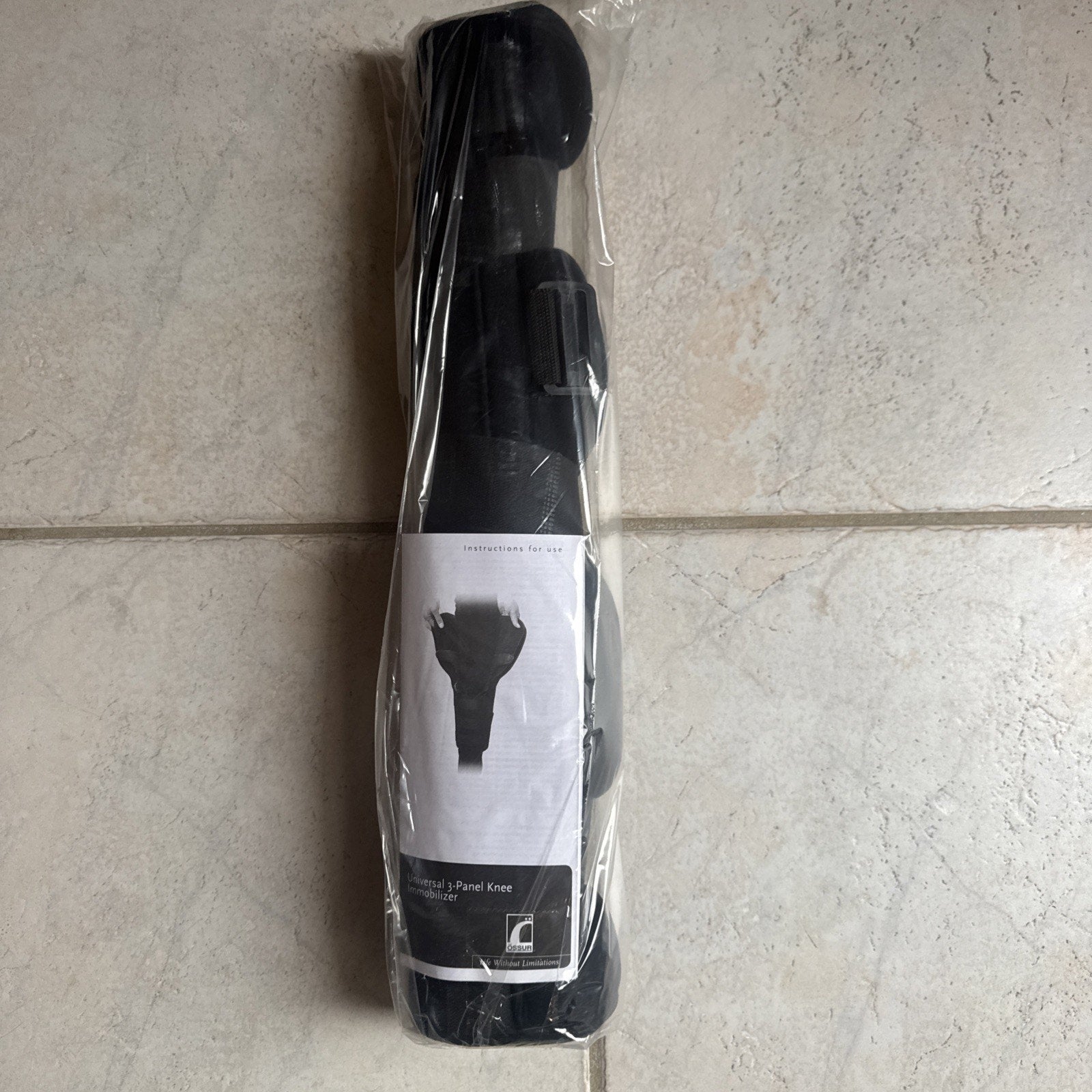 New Össur Knee Immobilizer Universal 3-Panel 22 inch model 200022 packaged in clear plastic wrap on tile floor