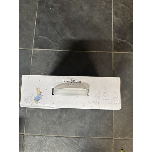 Beatrix Potter Peter Rabbit kids dinnerware set box with character illustrations and carrying handle on tiled floor