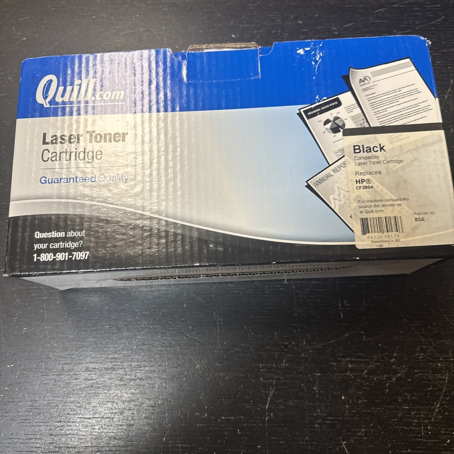 Cardboard packaging box for a Quill.com black laser toner cartridge compatible with HP CF280A printers, featuring product and support contact information on a blue and black gradient background.