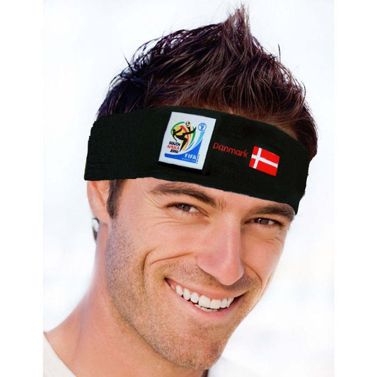 Man smiling and wearing a black headband featuring the 2010 FIFA World Cup South Africa logo, the Denmark flag, and "Danmark" text on a white background.