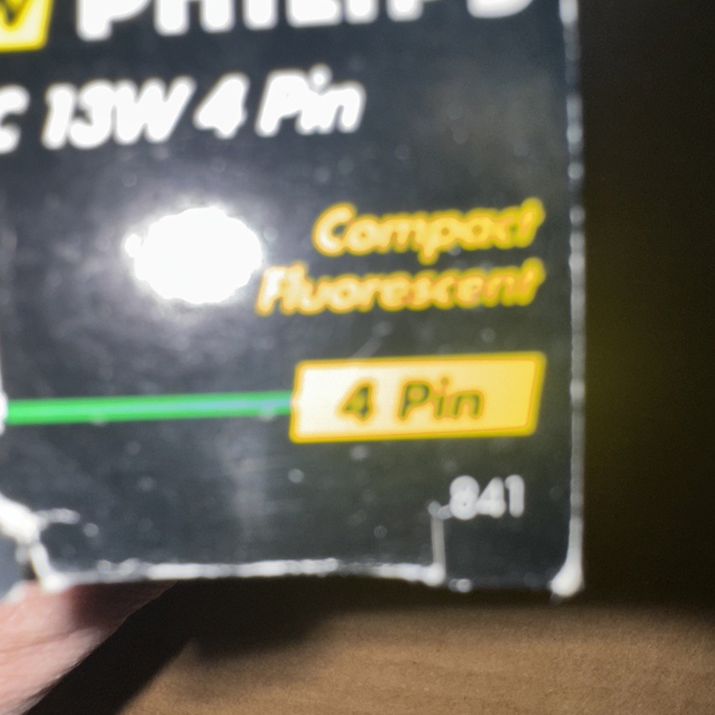 Close-up of PHILIPS PL-C 13W/835/4P ALTO compact fluorescent light bulb packaging showing 4 Pin detail