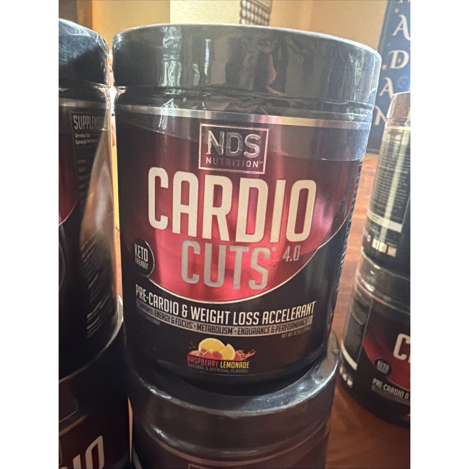 Black container of NDS Nutrition Cardio Cuts 4.0 pre-cardio and weight loss supplement with raspberry lemonade flavor, promoting energy, metabolism, focus, and endurance support.