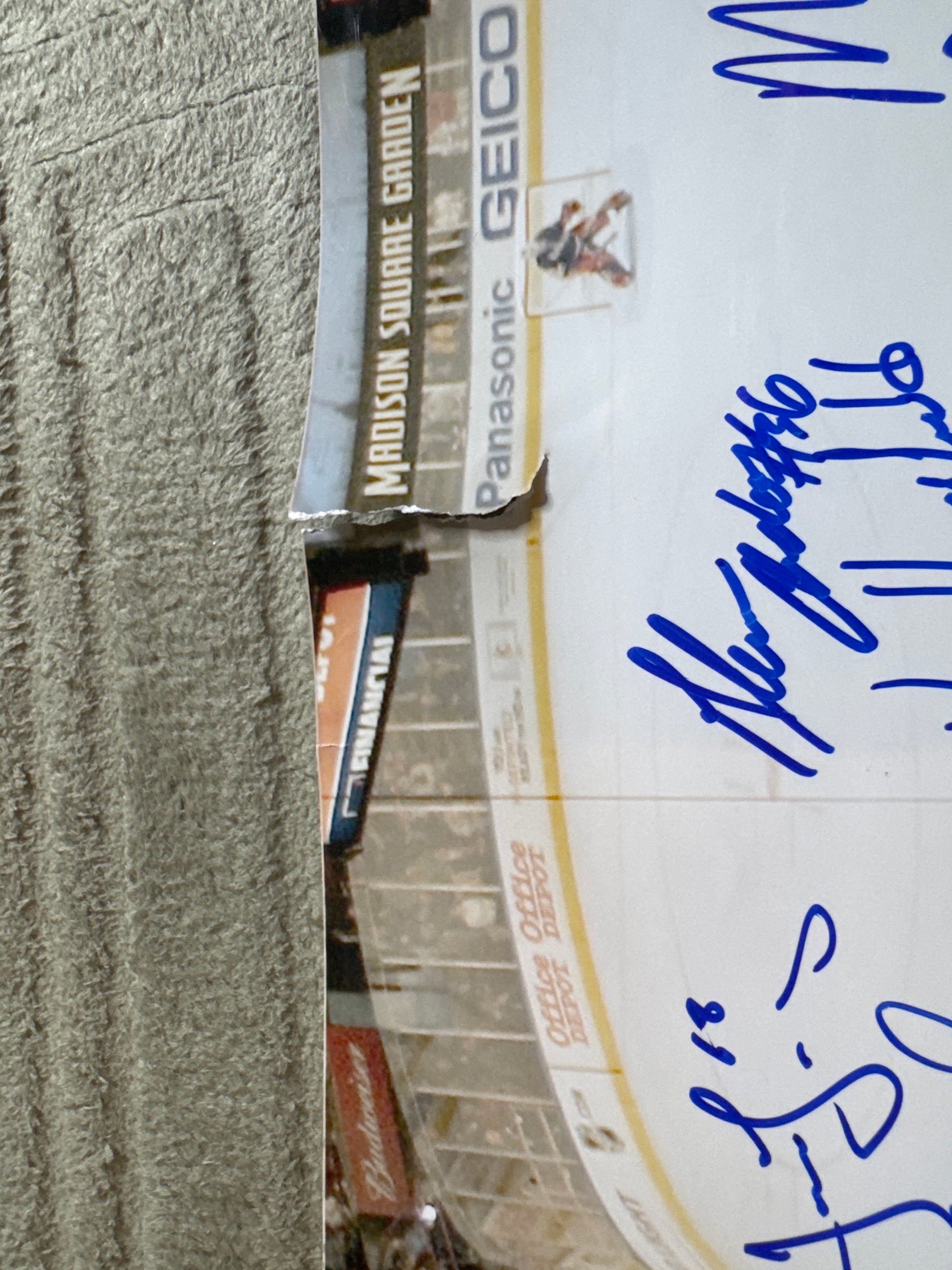 Close-up of Rangers 20x24 team-signed photo with visible signatures and Madison Square Garden advertising boards