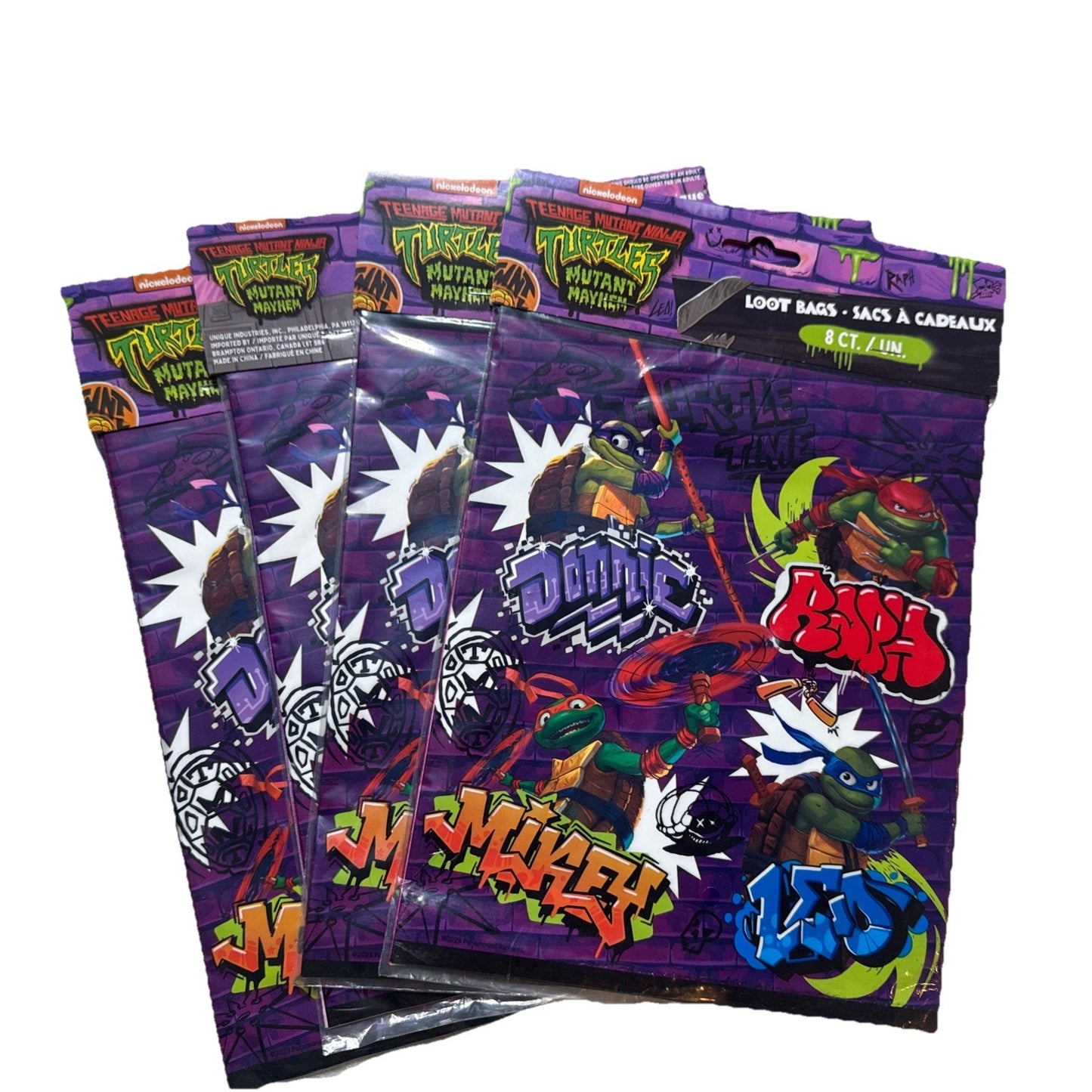 Teenage Mutant Ninja Turtles loot bags in purple with cartoon graphics and graffiti style text for party favors set