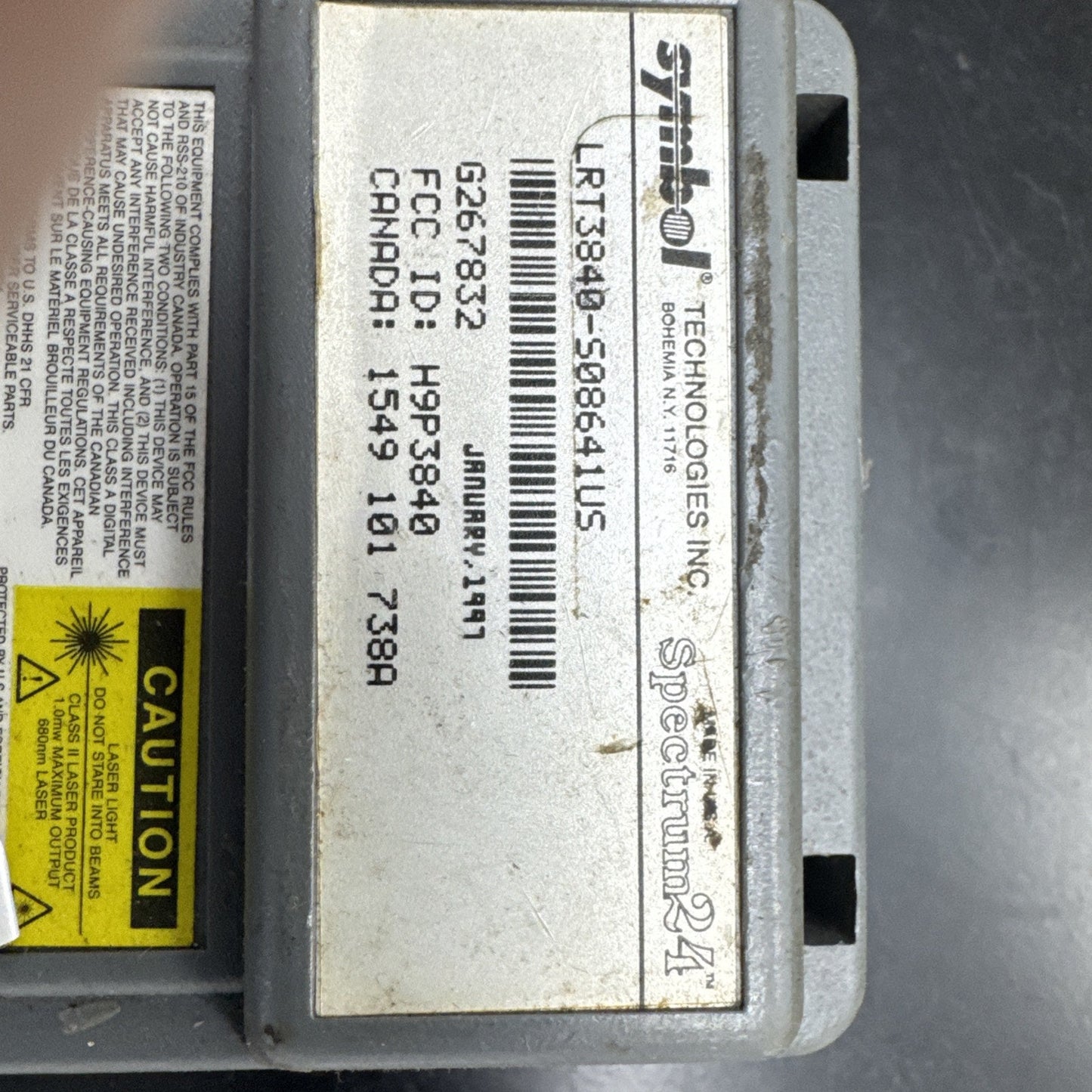 Close-up of Symbol Technologies Spectrum 24 barcode scanner label with model and certification details from 1997