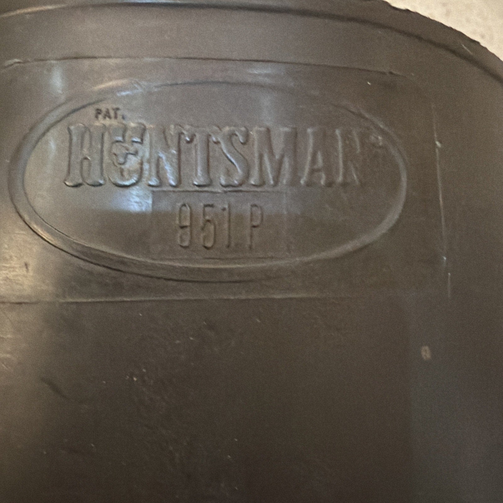 Close-up of black Huntsman 951P welding helmet label embossed on the protective gear surface