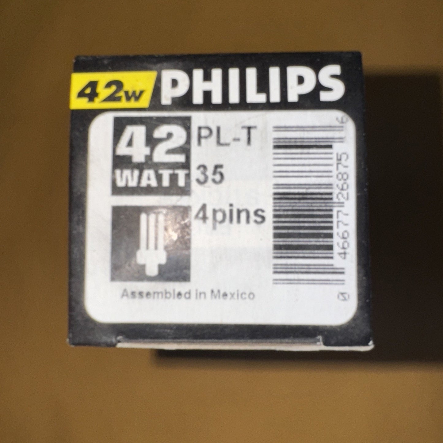 Box top of Philips 42w PL-T 4 pin compact fluorescent bulb with wattage and barcode label visible