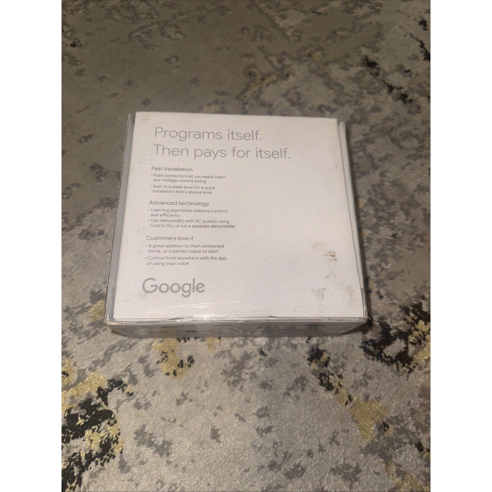 Google Nest Thermostat Pro Edition T3008US box showing product features and branding on a light surface