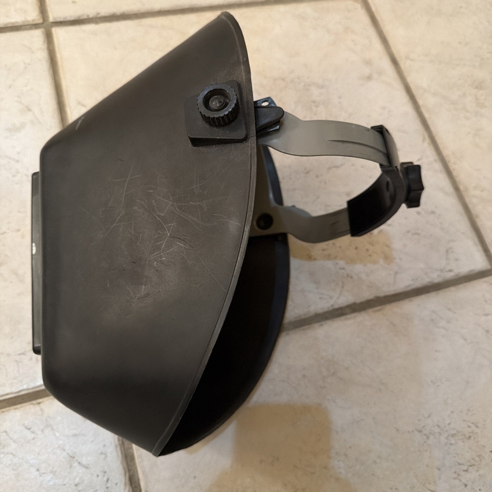 Jackson Safety HSL100 Glory Welding Helmet PRO-V auto darkening with adjustable headgear shown on tiled floor