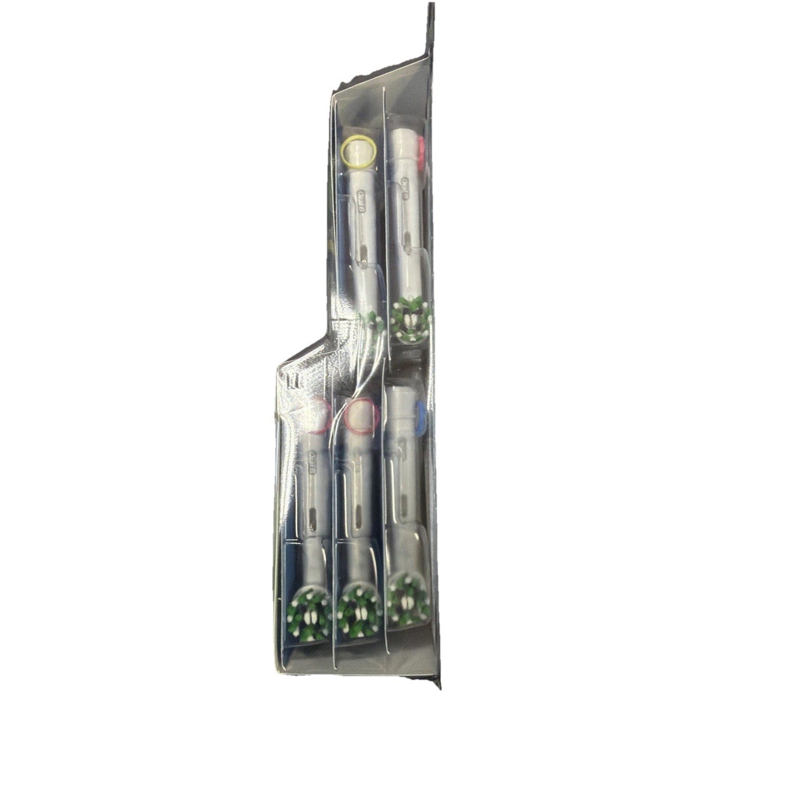 Side view of transparent plastic packaging containing five white dental or electric toothbrush heads with green and white bristles, each secured in separate compartments.