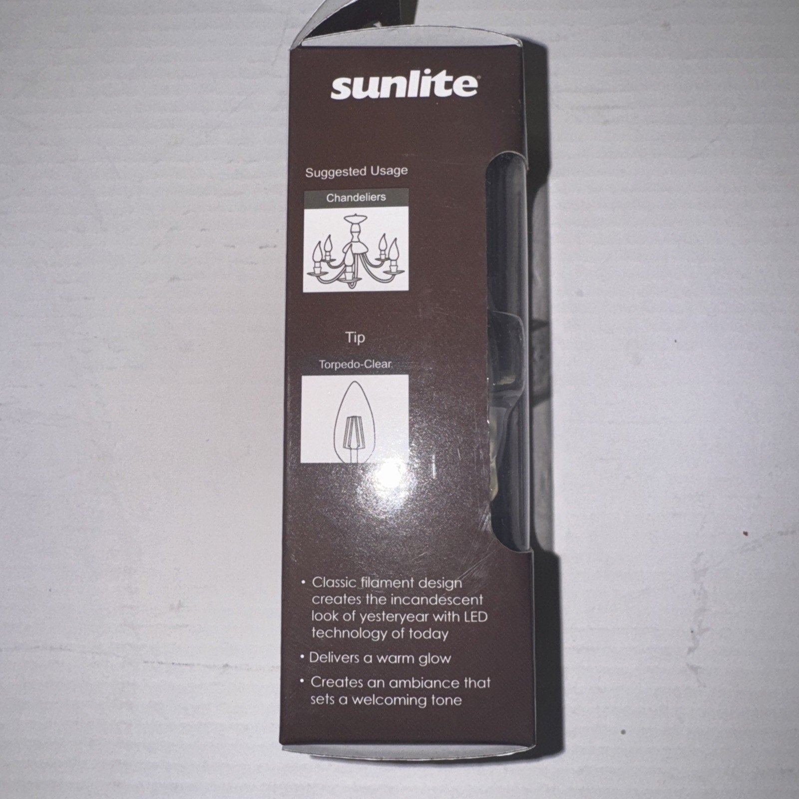 Sunlite LED filament chandelier bulb packaging showing suggested usage, tip style, and warm glow features in brown box