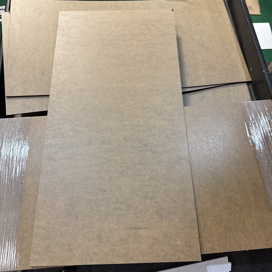 Black acrylic sheet 12x24 inch with protective brown paper covering on both sides showing thickness and edges
