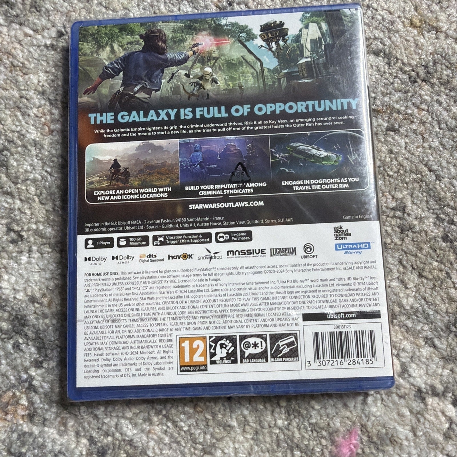 Back cover of a video game case showing gameplay scenes, text describing an open-world setting with criminal syndicates, game features, logos, rating information, and a barcode on a carpeted floor.