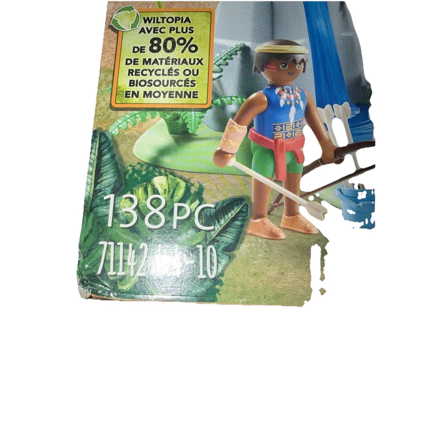 Close-up of a toy figure with a bow and arrow standing on a green leafy background, featuring a label indicating over 80% recycled or bio-based materials and the number 138 pieces.