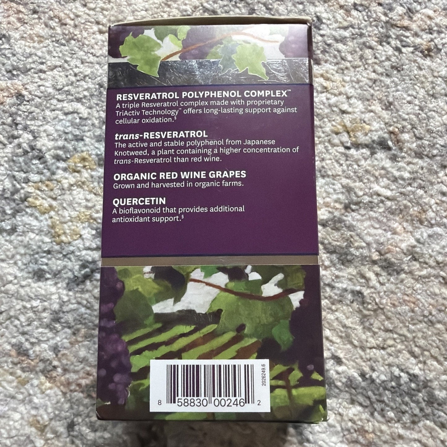 Back of a purple supplement box featuring descriptions of resveratrol polyphenol complex ingredients including trans-resveratrol from Japanese Knotweed, organic red wine grapes, and quercetin, with a barcode at the bottom.