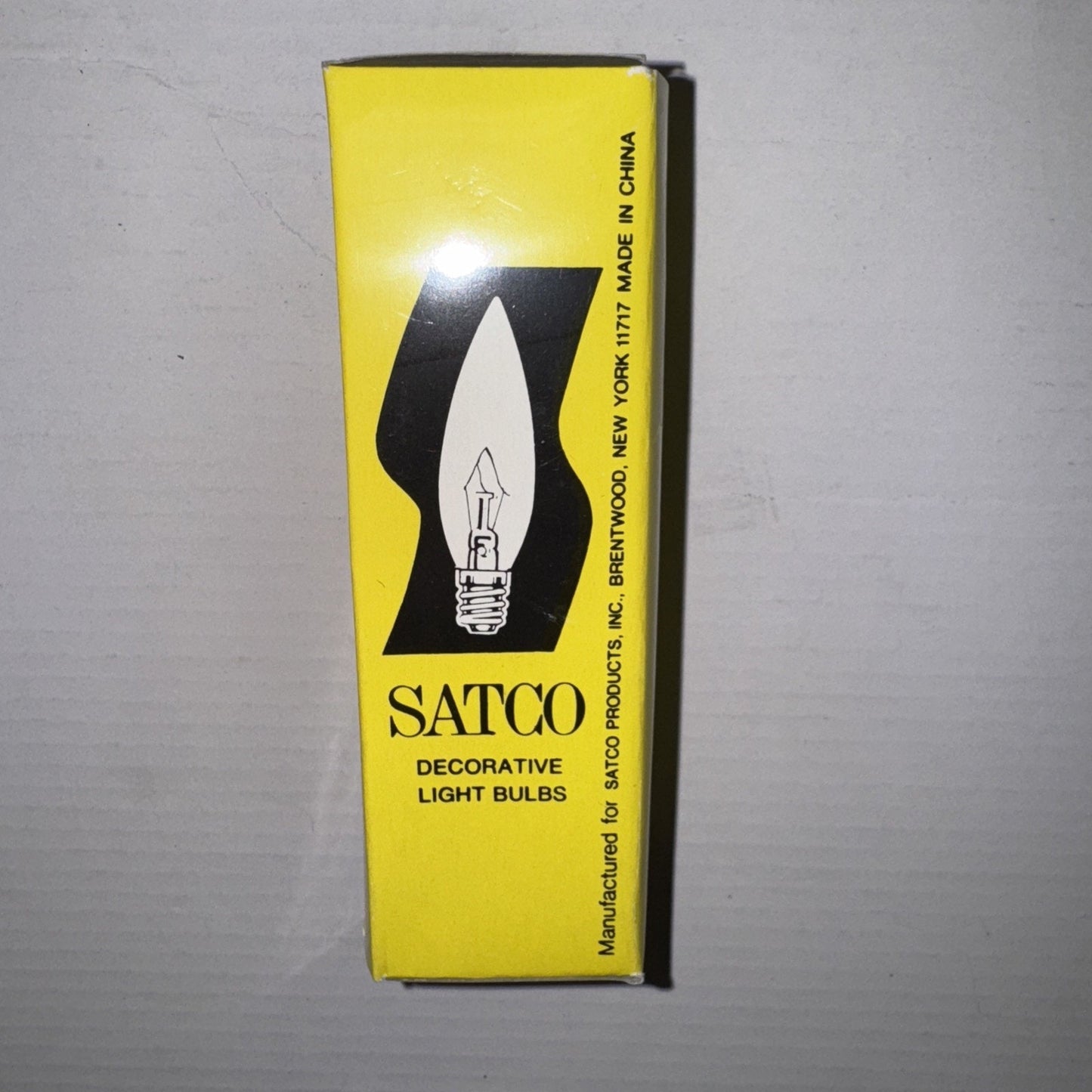 Yellow Satco box packaging for S3387 40 watt clear decorative torpedo light bulb with black text and bulb illustration
