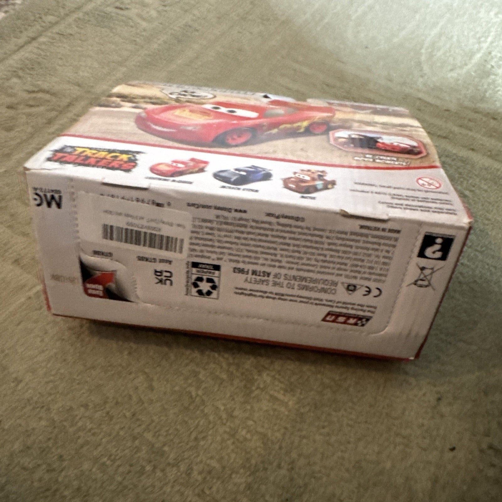Disney Pixar Cars Track Talkers Lightning McQueen toy box showing red race car with sound features and phrases on packaging