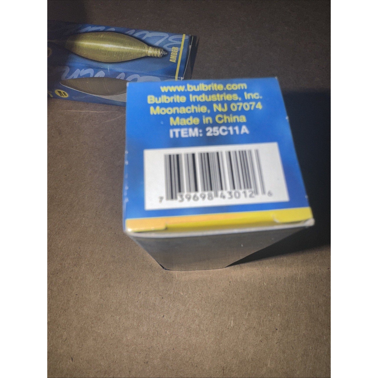 Top view of Bulbrite Industries lightbulb box with barcode and product information printed on blue background