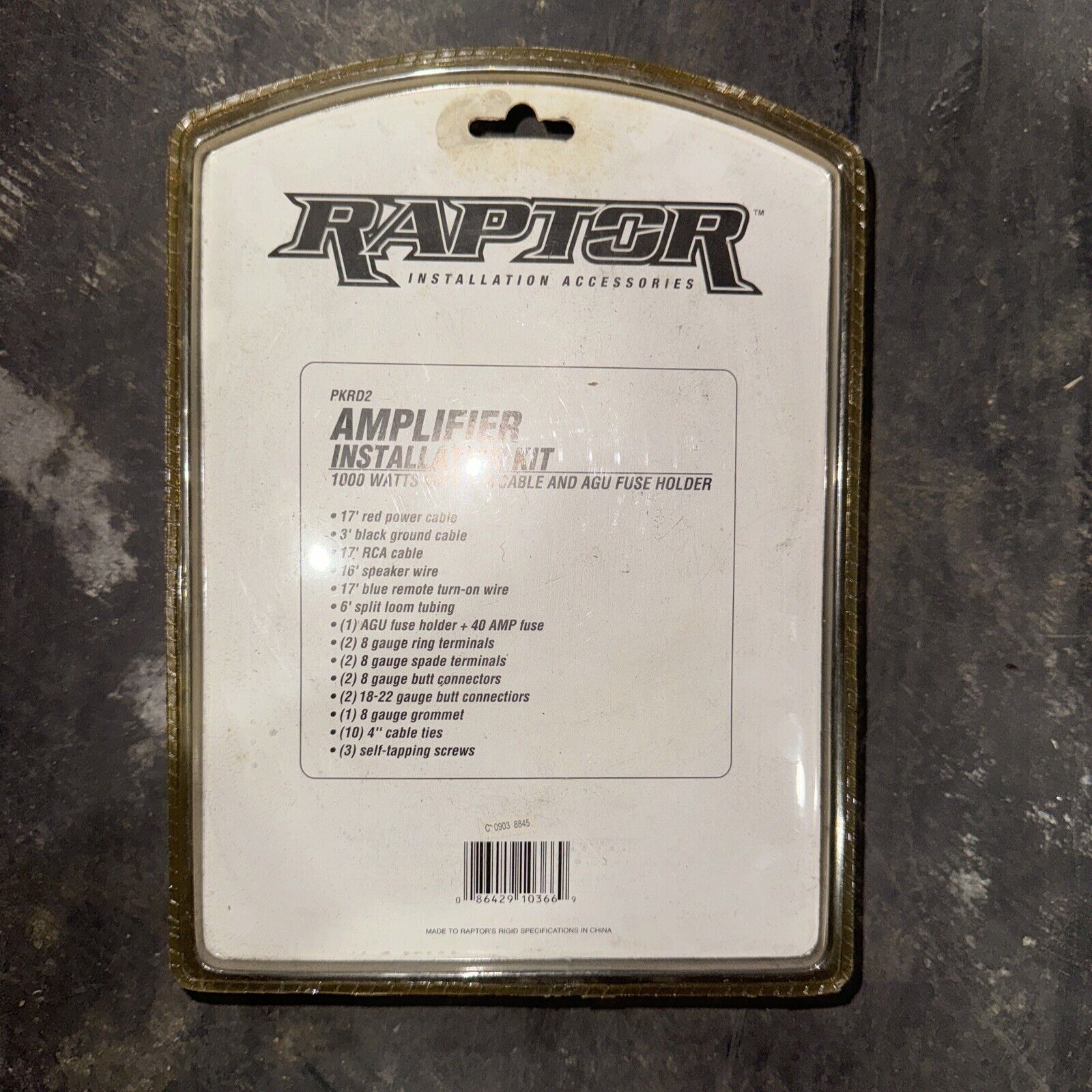 Raptor amplifier installation kit packaging showing included cables, terminals, fuses, and screws for audio setup