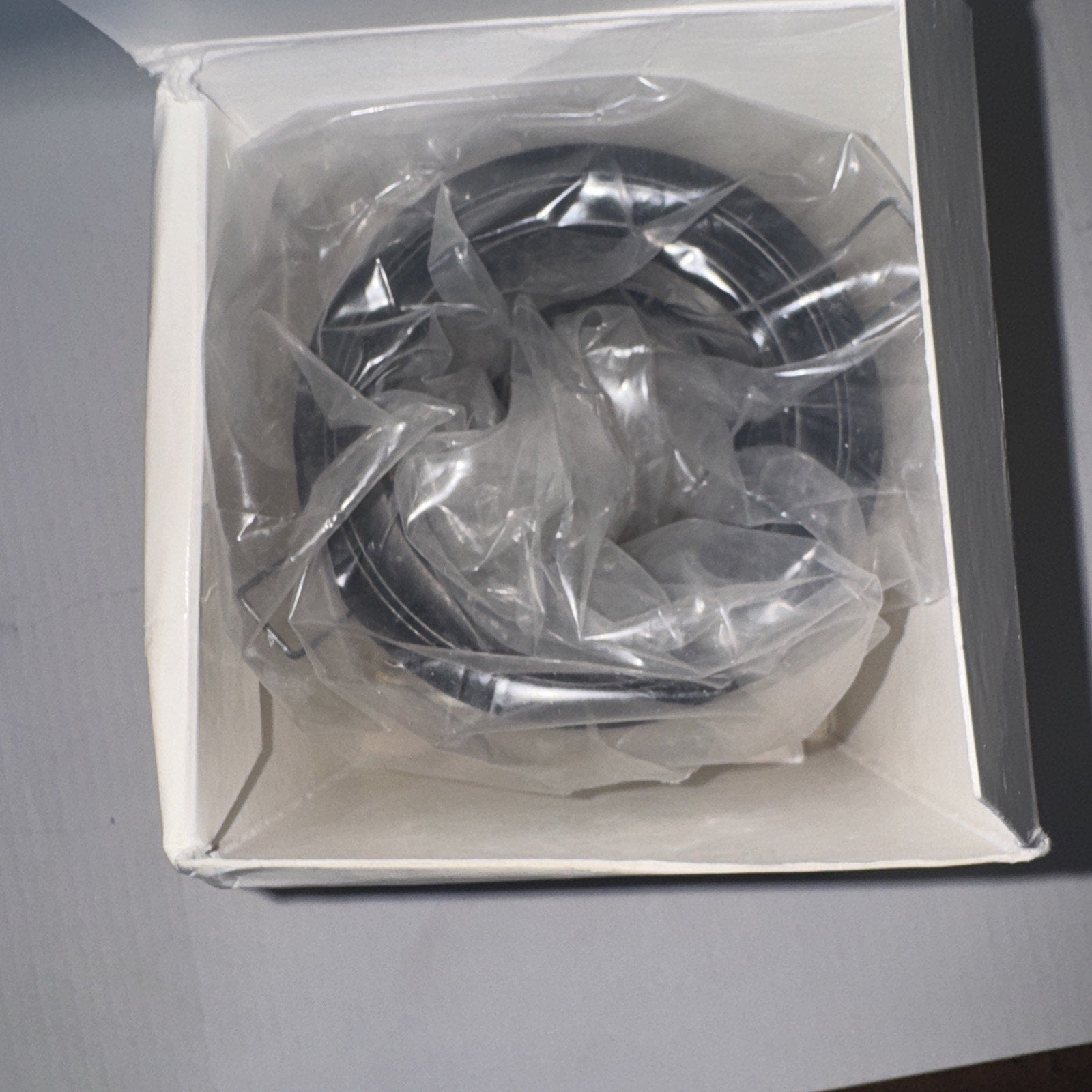 Futura Lighting MR16low 1705-01 recessed downlight body in plastic wrap inside white packaging box viewed from top