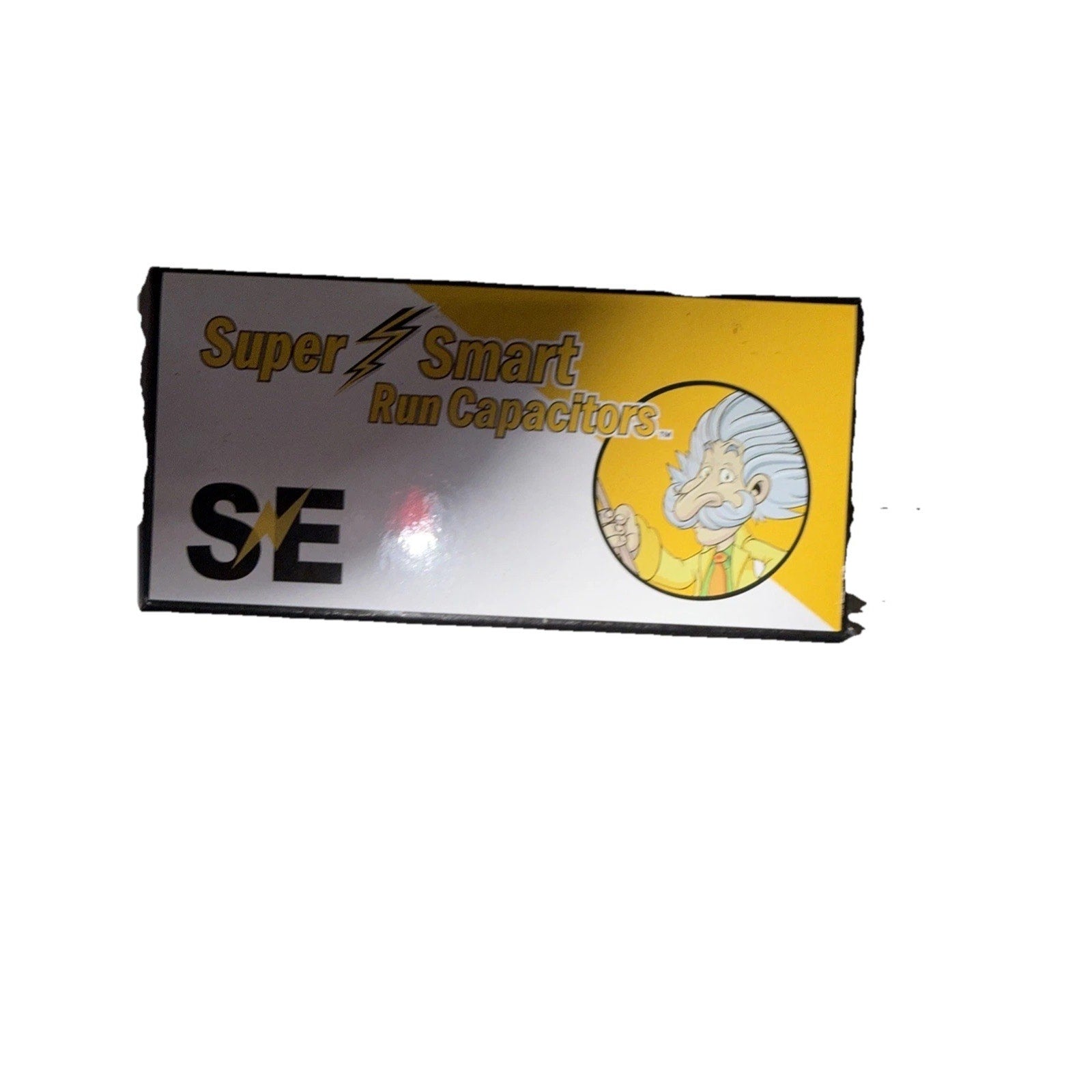 Rectangular box with a yellow and white design featuring the text "Super Smart Run Capacitors" alongside a cartoon illustration of a smiling scientist with white hair and a mustache.